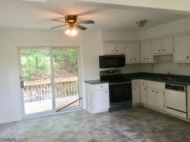 a kitchen with a stove a sink and a microwave