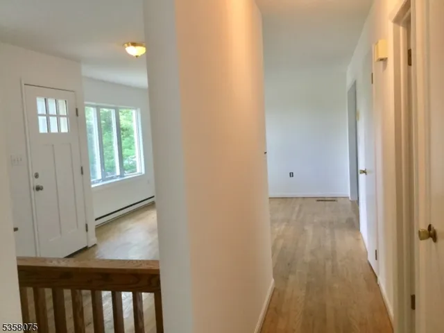 a view of hallway with wooden floor