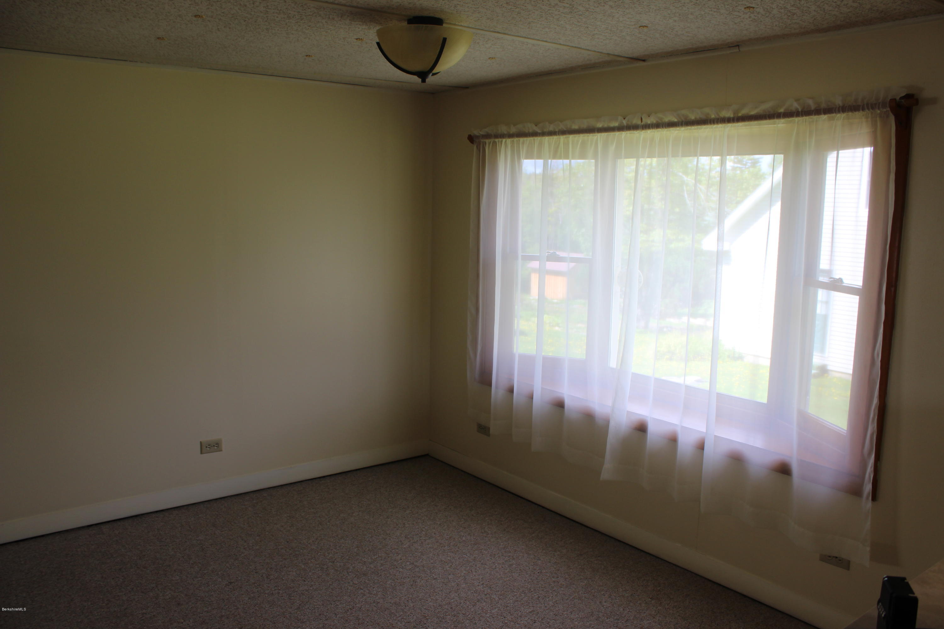 140 Windsor Road Savoy, MA 01256 - Photo 4 of 16 a view of an empty room and a window