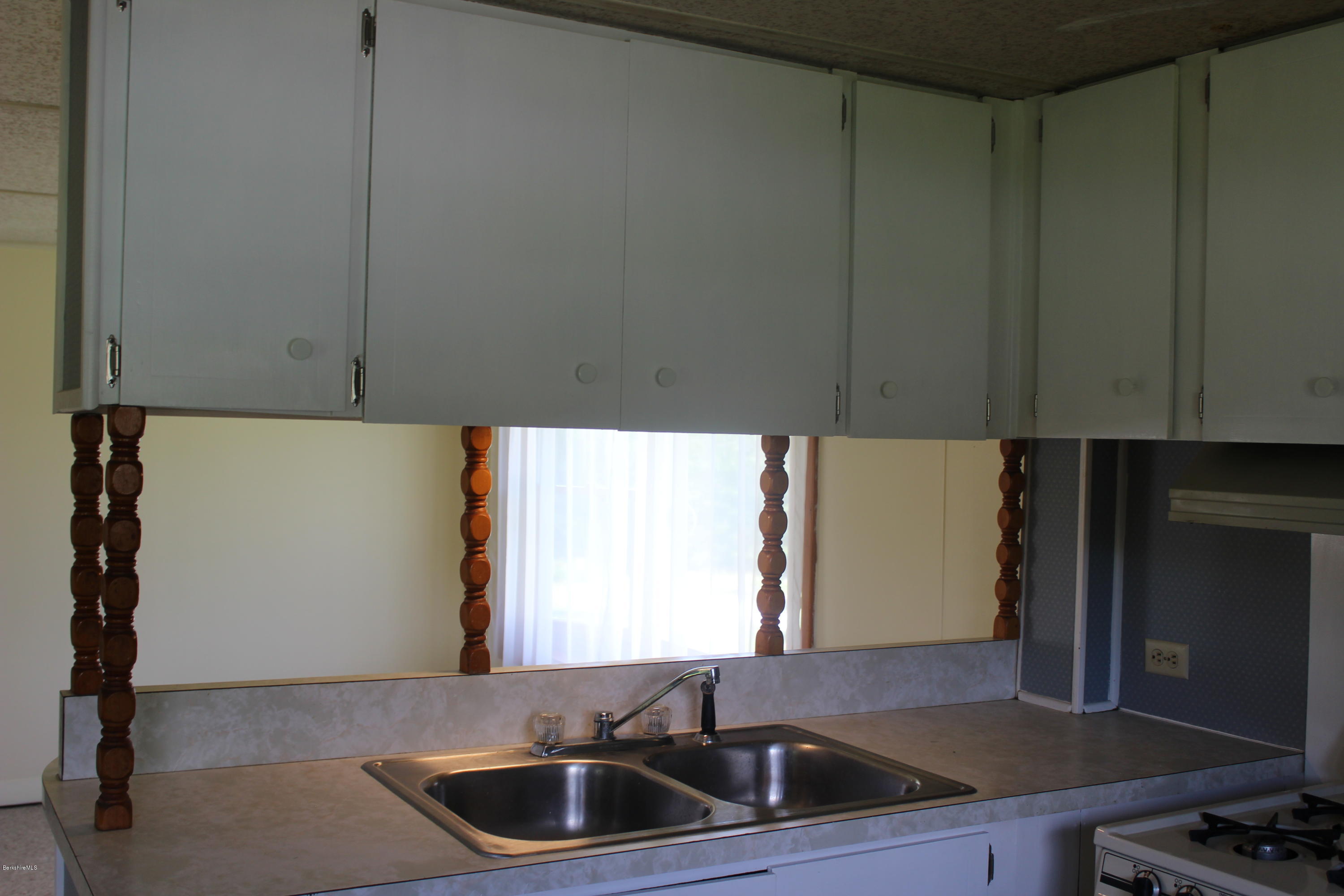 140 Windsor Road Savoy, MA 01256 - Photo 9 of 16 a kitchen with a sink cabinets and a window