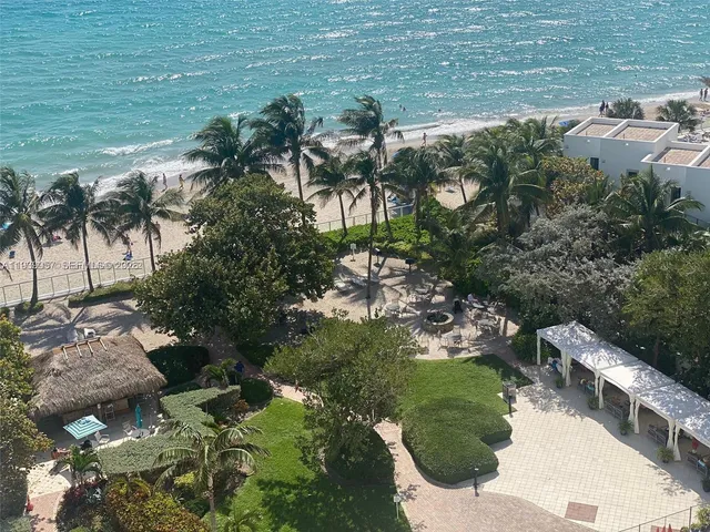 a backyard of a house with a yard and outdoor seating