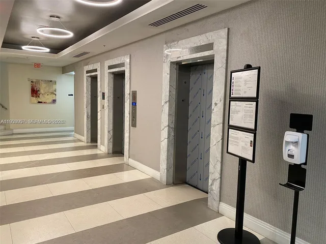 a view of a hallway with wooden floor and entryway