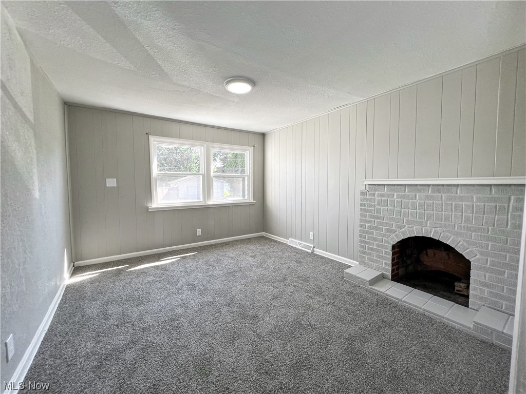 602 West Marshall Road McDonald, OH 44437 - Photo 9 of 19 Unfurnished Master bedroom with a textured ceiling, carpet, and a fireplace