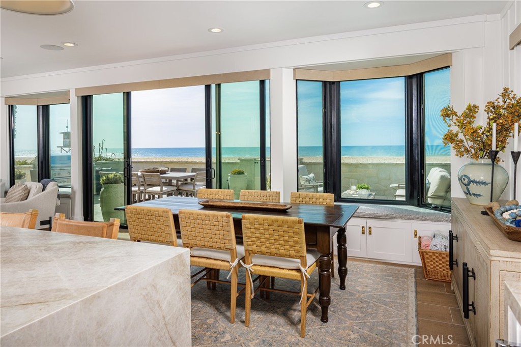 6110 West Oceanfront Newport Beach, CA 92663 - Photo 11 of 33 a very nice looking living room with a large window and dining table