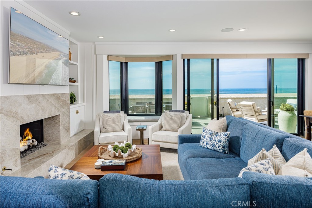 6110 West Oceanfront Newport Beach, CA 92663 - Photo 12 of 33 a living room with furniture and a fireplace