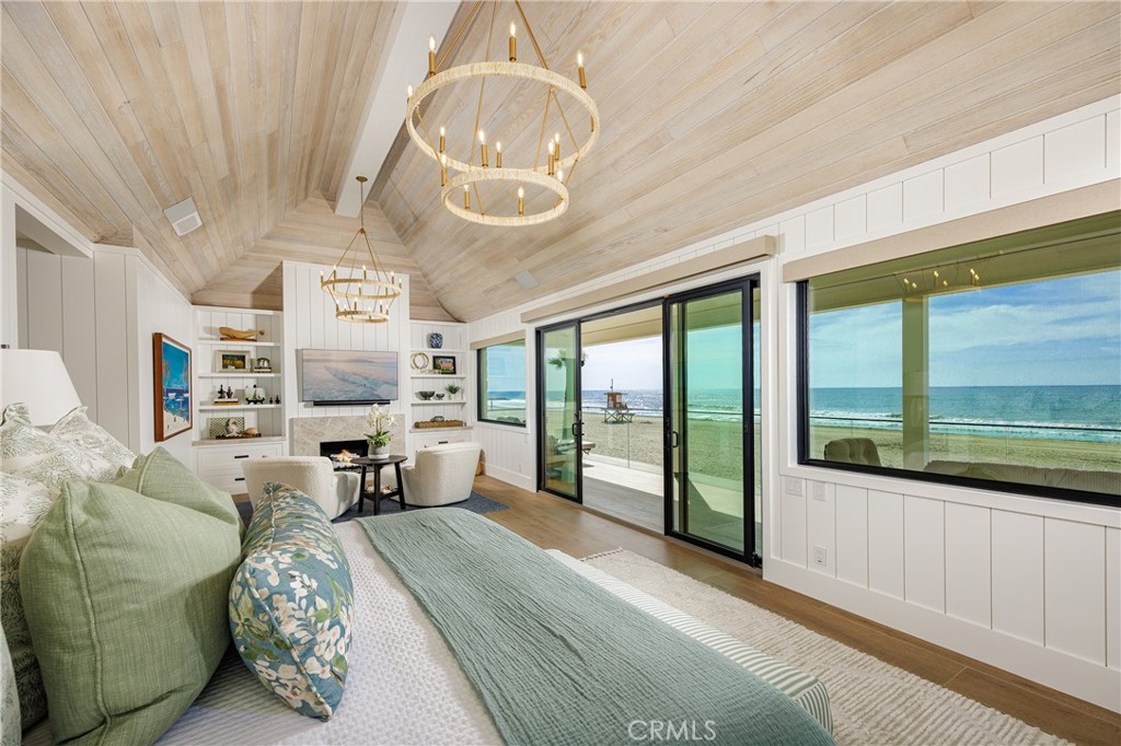 6110 West Oceanfront Newport Beach, CA 92663 - Photo 16 of 33 a bedroom with furniture and large windows