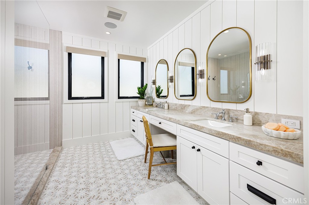 6110 West Oceanfront Newport Beach, CA 92663 - Photo 18 of 33 a bathroom with a double vanity sink and a window