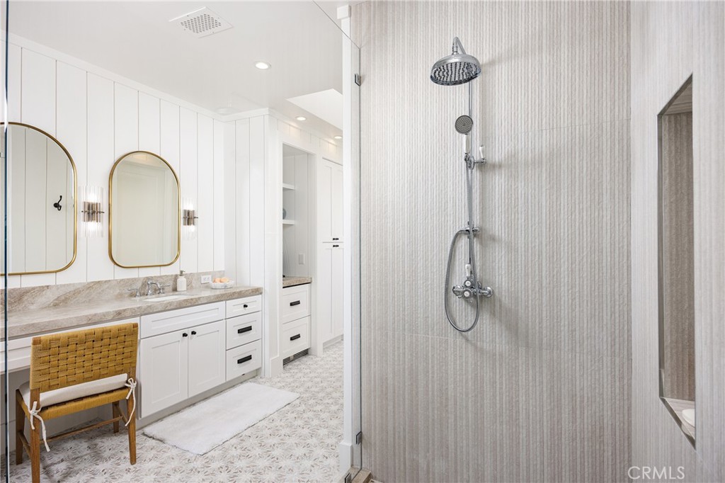6110 West Oceanfront Newport Beach, CA 92663 - Photo 19 of 33 a bathroom with a granite countertop sink two mirror and shower