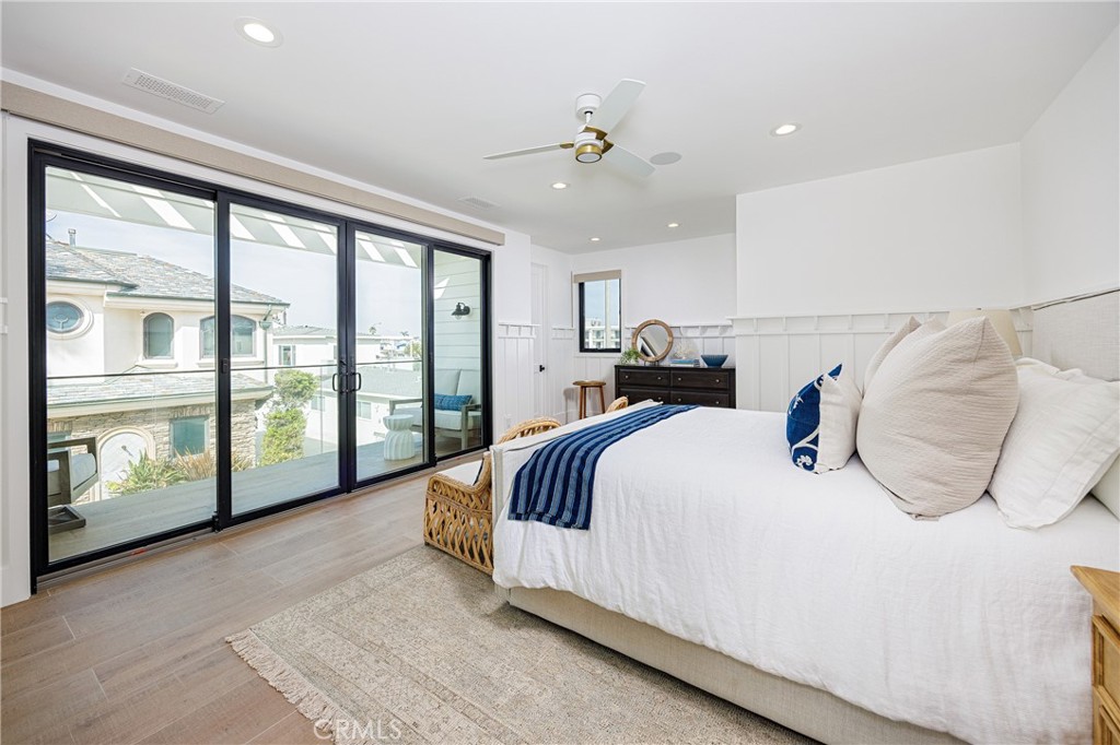 6110 West Oceanfront Newport Beach, CA 92663 - Photo 22 of 33 a bedroom with a large bed and a large window
