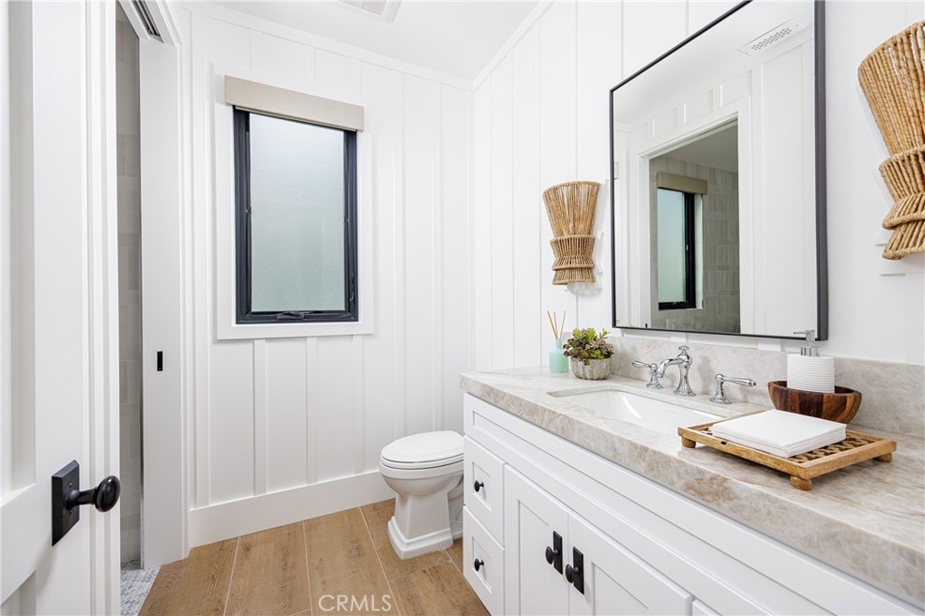 6110 West Oceanfront Newport Beach, CA 92663 - Photo 25 of 33 a bathroom with a granite countertop sink mirror and toilet
