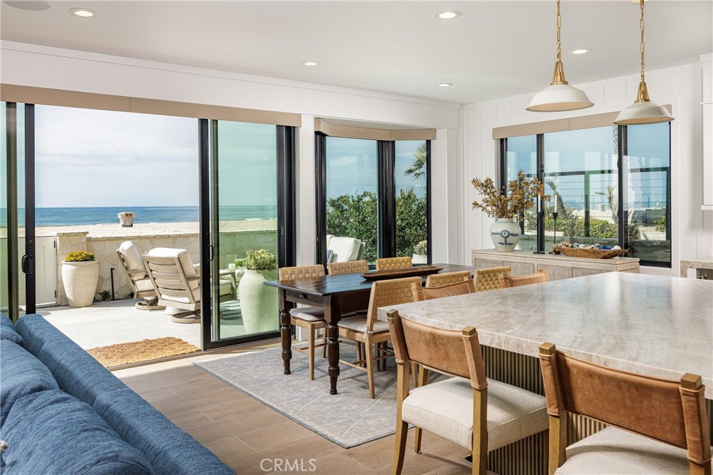 6110 West Oceanfront Newport Beach, CA 92663 - Photo 10 of 33 a dining room with granite countertop a couch a table and chairs