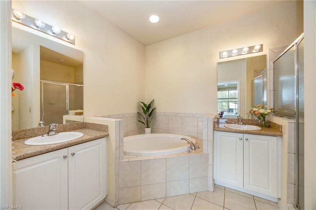 7920 Mahogany Run Lane, Unit 1024 Naples, FL 34113 - Photo 19 of 28 Primary bath with soaking tub, walk-in shower complete with dual vanities.