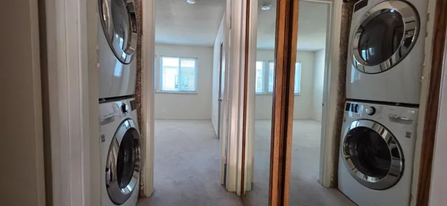 a view of a hallway with washer and dryer
