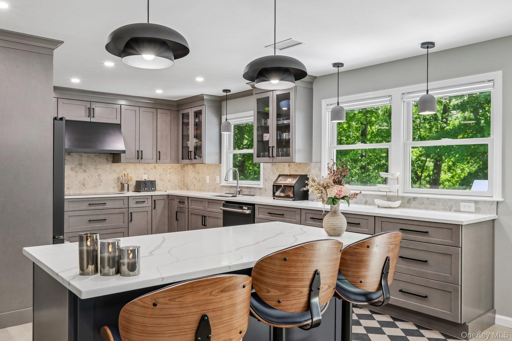 62 Mohegan Road Larchmont, NY 10538 - Photo 22 of 46 a kitchen with stainless steel appliances granite countertop a sink a stove and a refrigerator with wooden floor