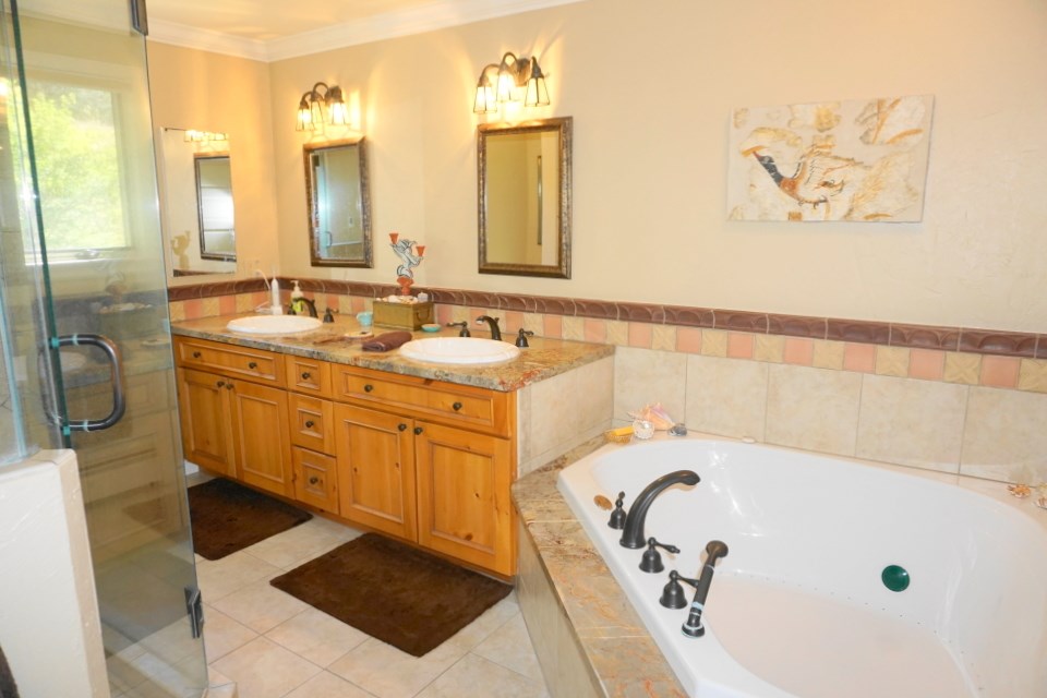 42265 Piburn Flats Road Crawford, CO 81415 - Photo 10 of 35 a bathroom with a tub sink and mirror