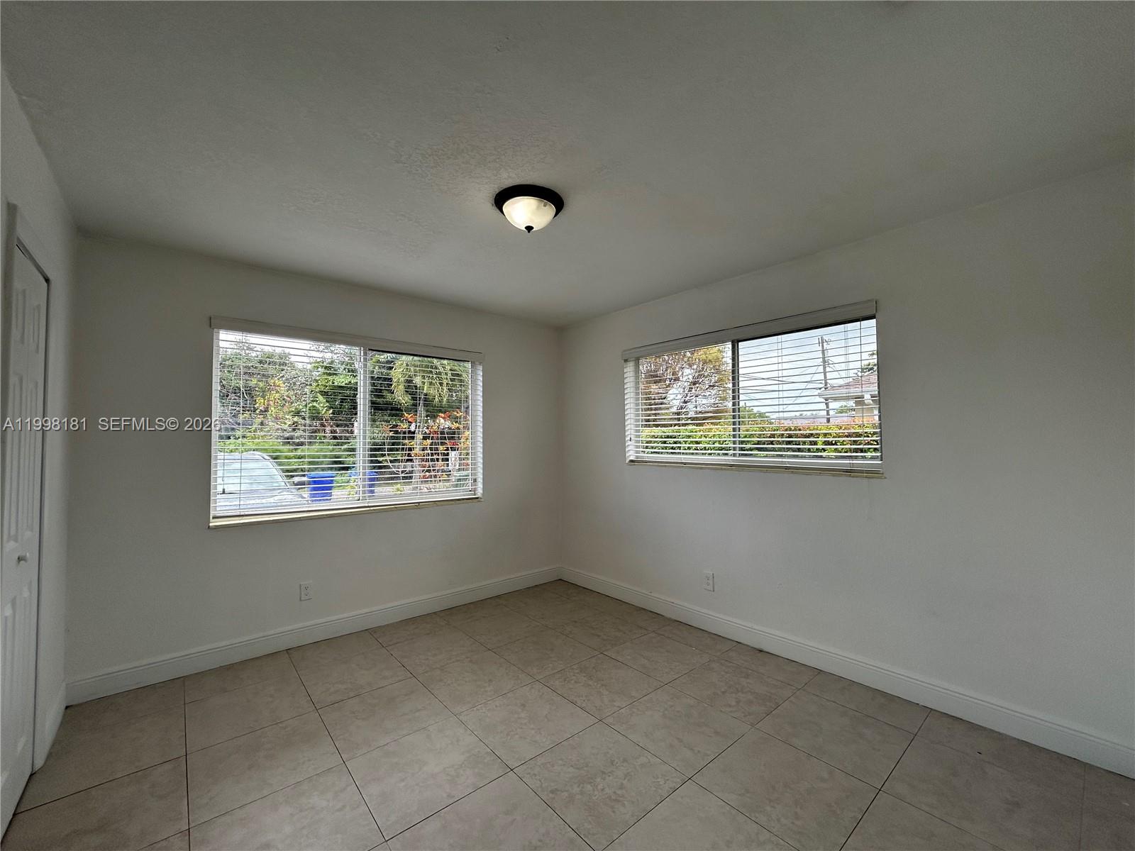 2804 Southwest 35th Avenue, Unit 2804 Miami, FL 33133 - Photo 11 of 22 an empty room with a window