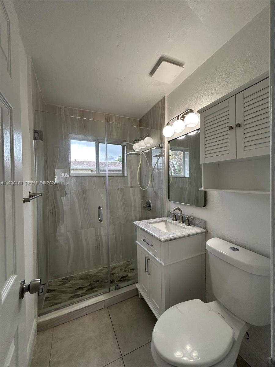2804 Southwest 35th Avenue, Unit 2804 Miami, FL 33133 - Photo 12 of 22 a bathroom with a sink a toilet and shower