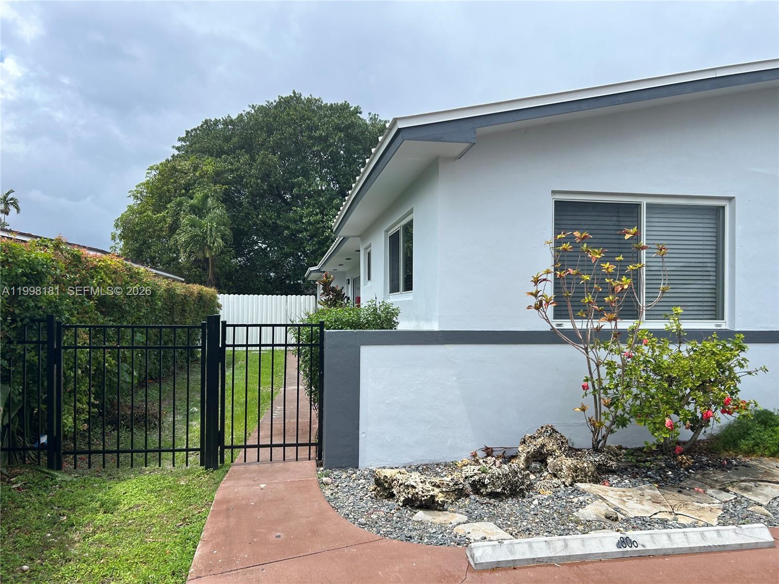 2804 Southwest 35th Avenue, Unit 2804 Miami, FL 33133 - Photo 21 of 22 a front view of a house with garden
