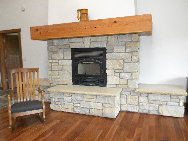 5255 Yale Bridge Road Rockton, IL 61072 - Photo 8 of 25 a living room with furniture wooden floor and a fireplace