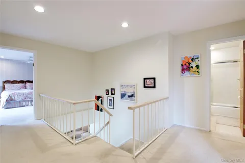 a view of a hallway with a couch and stairs