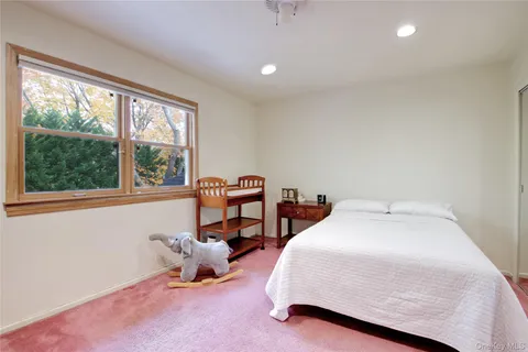 a bedroom with bed and a window