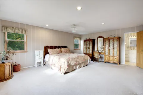 a spacious bedroom with a bed and a couch