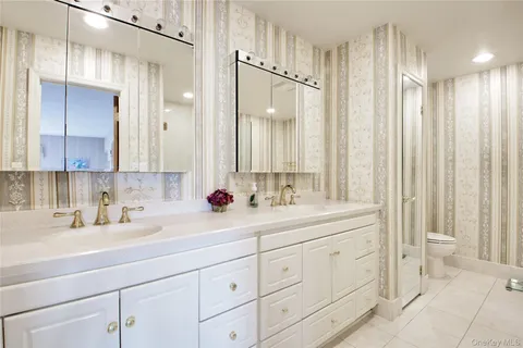 a bathroom with a double vanity sink mirror and