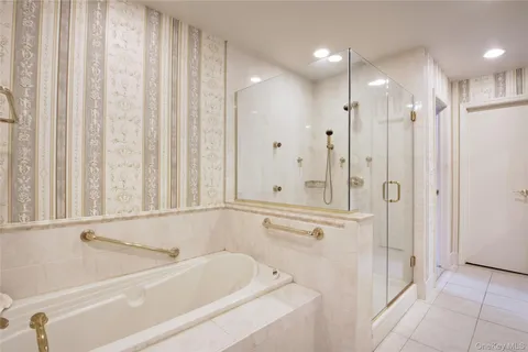 a bathroom with a bathtub and a shower