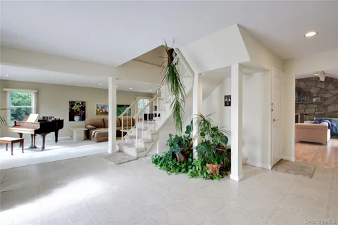 a living room with furniture and a potted plant