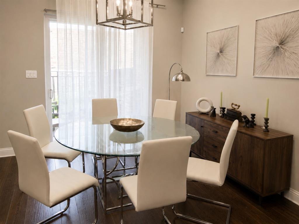 8235 Snapdragon Way Dallas, TX 75252 - Photo 11 of 29 Dining area featuring wood-finish flooring, a contemporary chandelier, and a sliding glass door