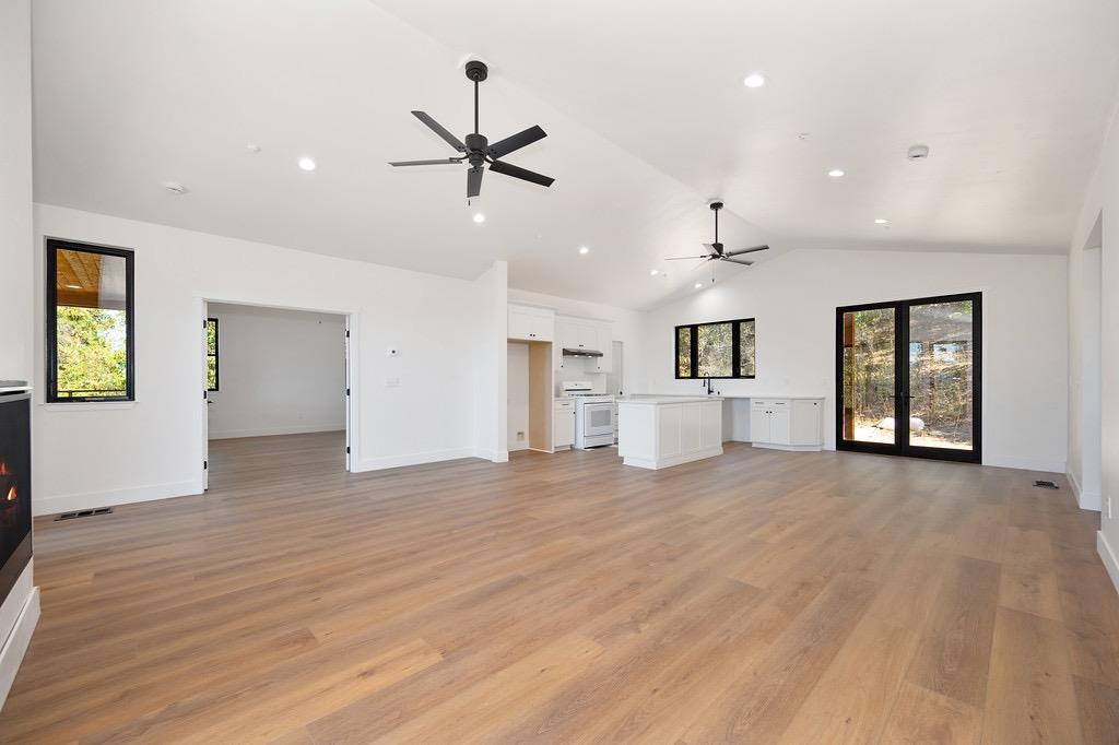 5205 Rooster Lane Somerset, CA 95684 - Photo 19 of 98 a view of an empty room with a window and wooden floor