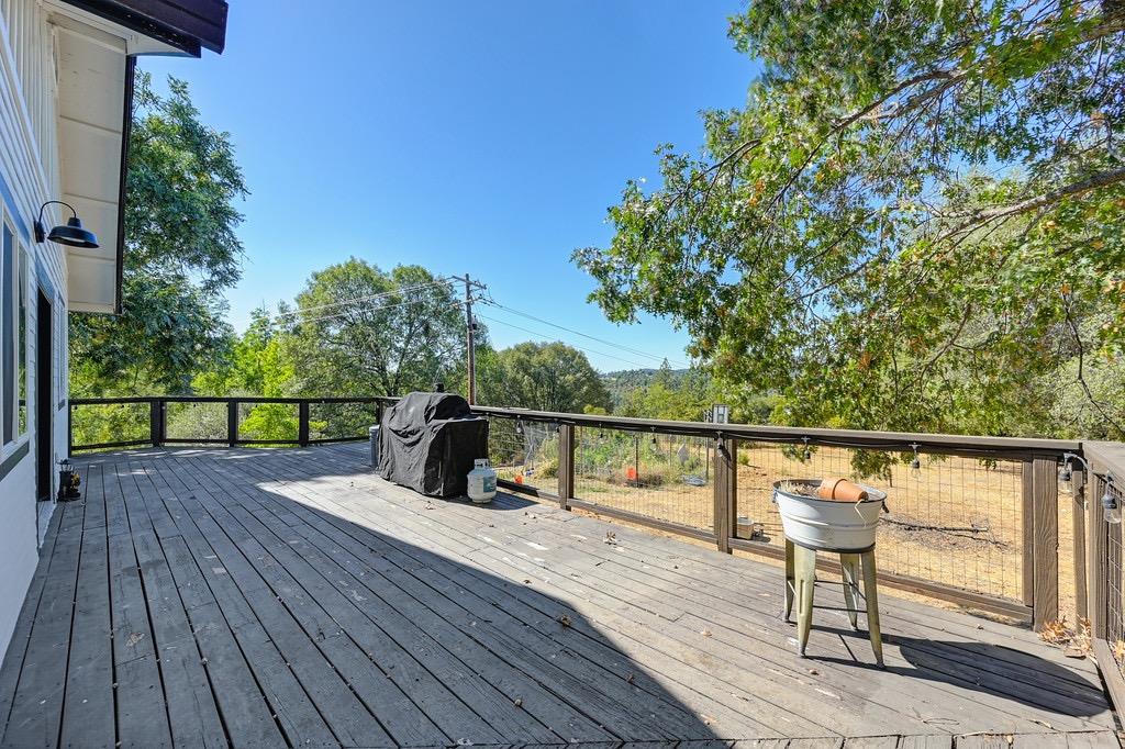 5205 Rooster Lane Somerset, CA 95684 - Photo 30 of 98 a view of a balcony with wooden floor and iron fence