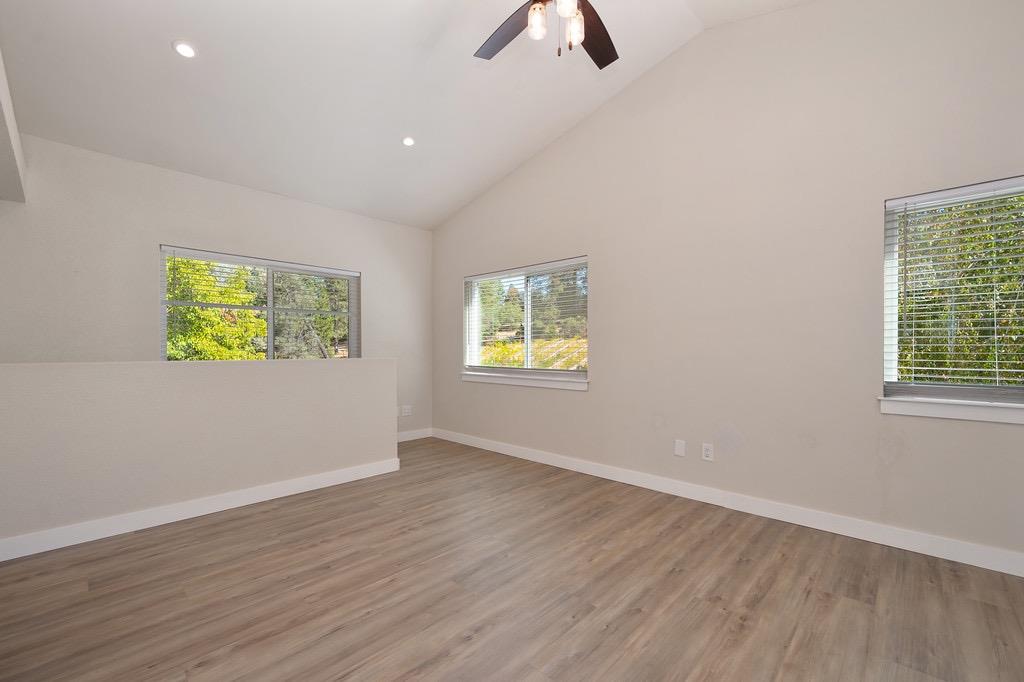5205 Rooster Lane Somerset, CA 95684 - Photo 36 of 98 a view of an empty room with window and wooden floor