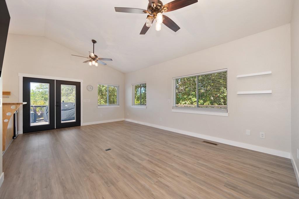 5205 Rooster Lane Somerset, CA 95684 - Photo 43 of 98 an empty room with wooden floor chandelier and windows