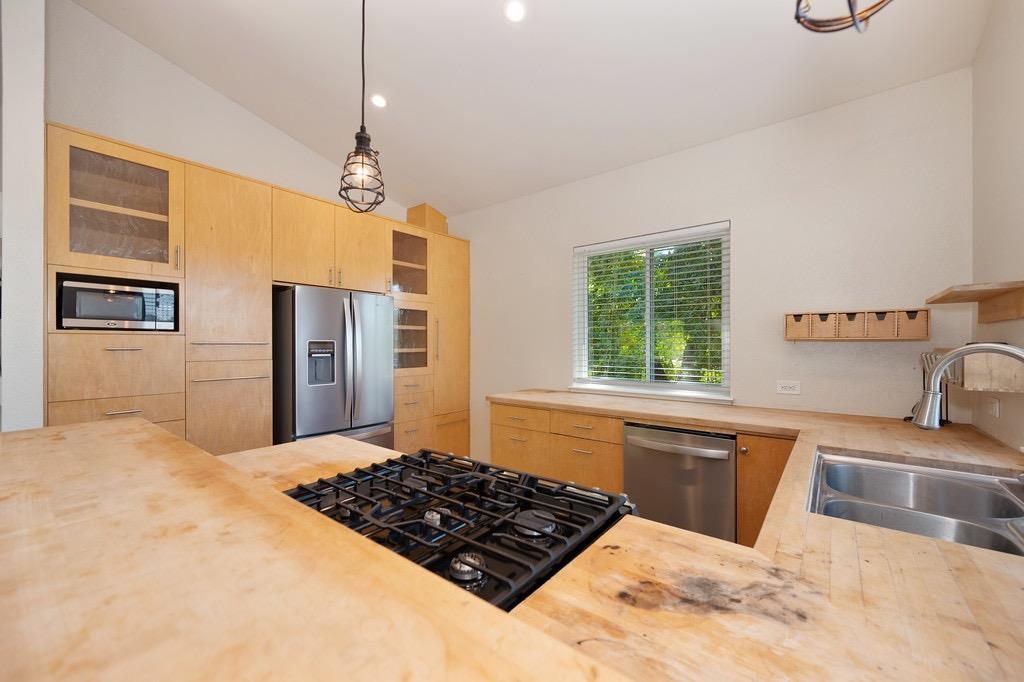 5205 Rooster Lane Somerset, CA 95684 - Photo 47 of 98 a kitchen with stainless steel appliances granite countertop a sink stove and refrigerator