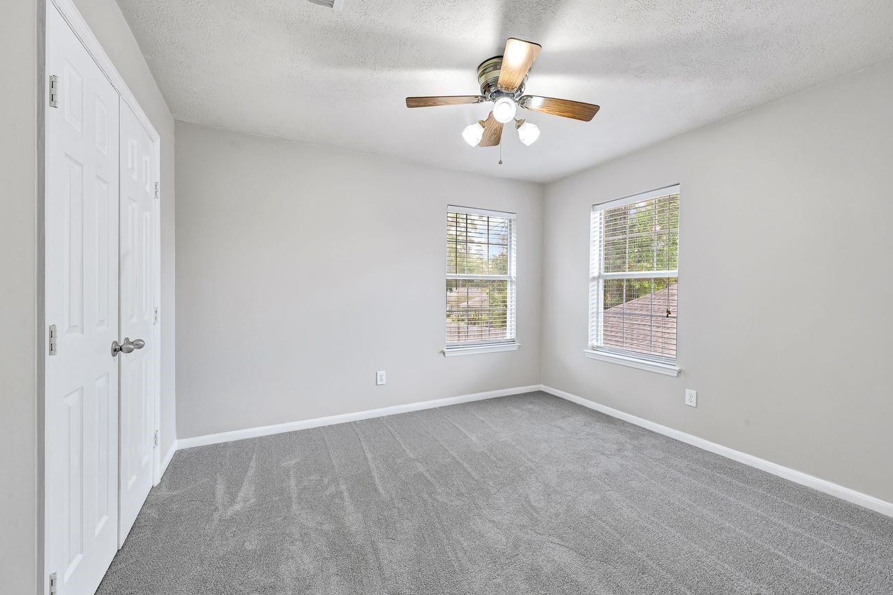 19126 South Rim Trail Spring, TX 77388 - Photo 20 of 21 an empty room with chandelier fan and windows