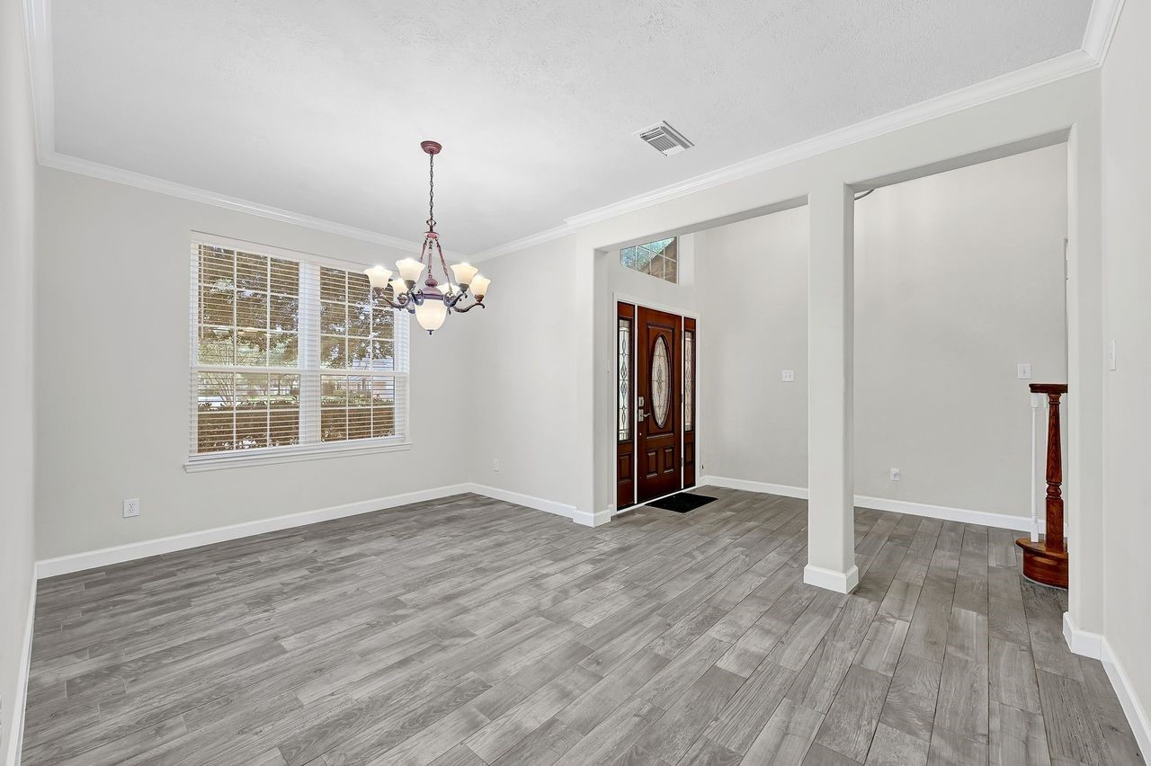 19126 South Rim Trail Spring, TX 77388 - Photo 5 of 21 a view of an empty room with window and wooden floor