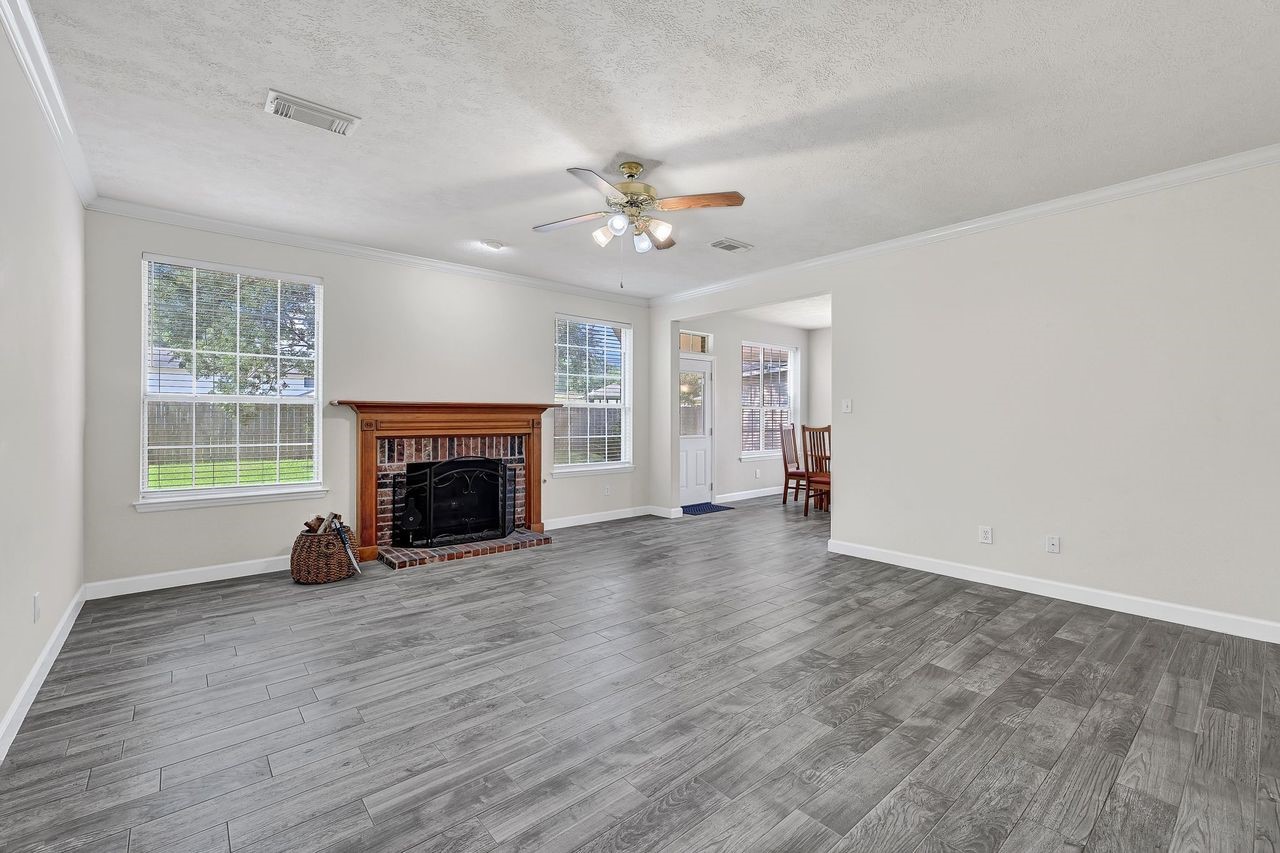 19126 South Rim Trail Spring, TX 77388 - Photo 6 of 21 an empty room with windows and a fireplace