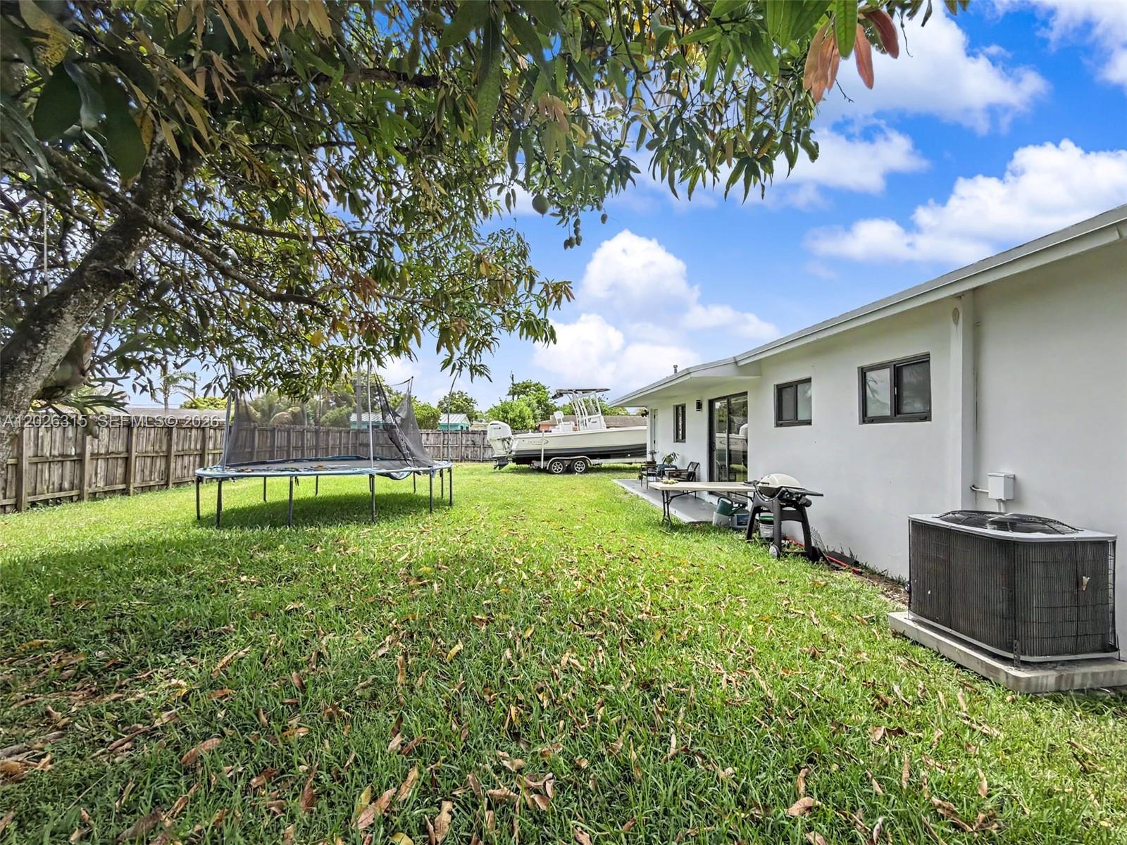 10762 Southwest 145th Street Miami, FL 33176 - Photo 23 of 28 a view of a backyard with table and chairs and garden