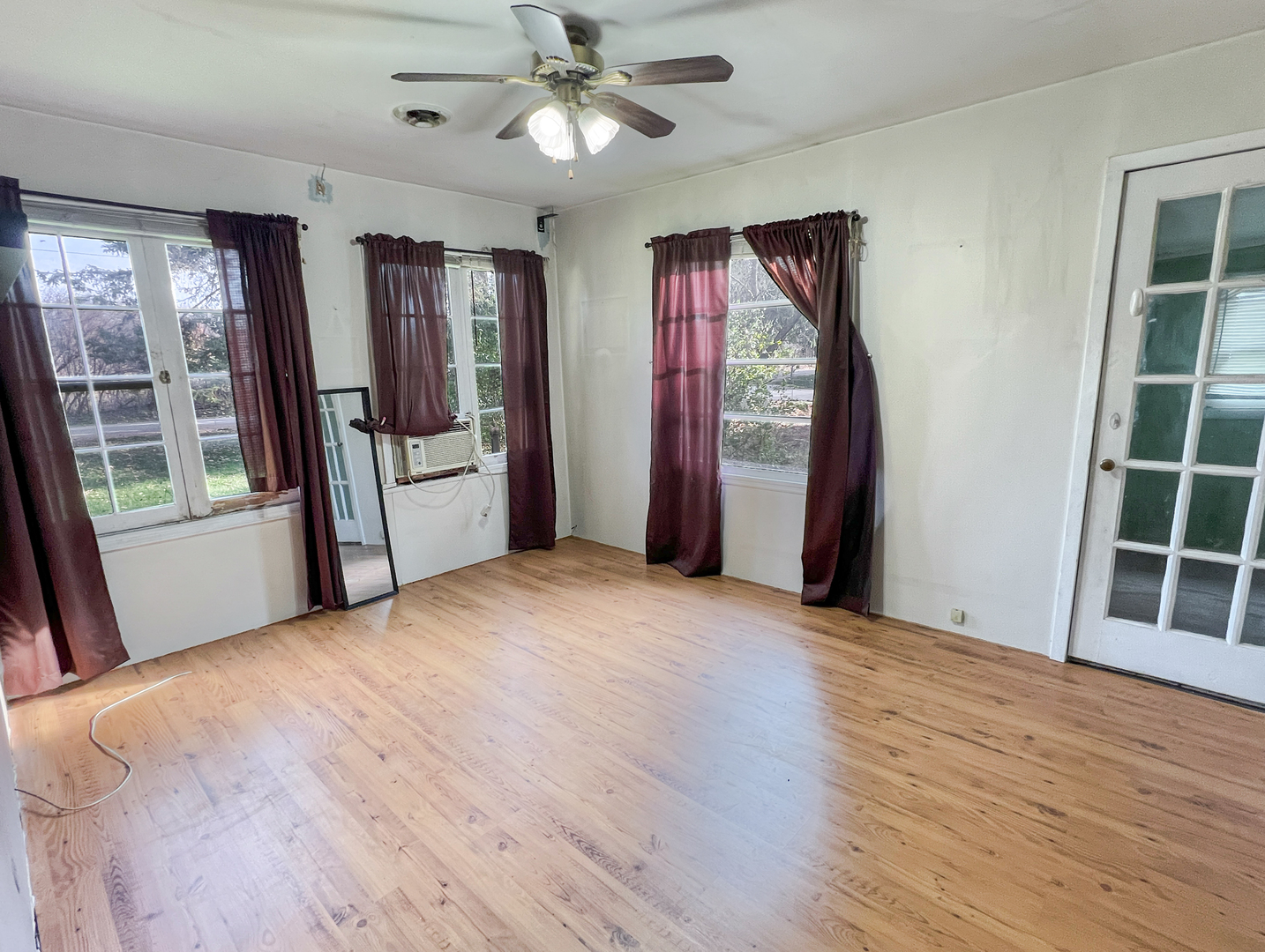 10 Hilltop Road Cary, IL 60013 - Photo 3 of 13 a view of an empty room with a window and wooden floor