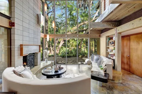 a living room with furniture a dining table and chairs