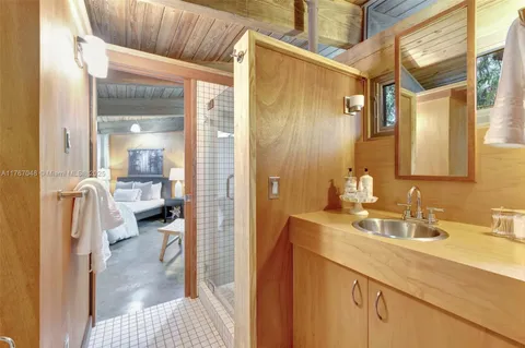 a dining room with wooden floor and large windows