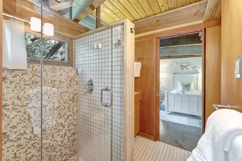 a living room with patio furniture and a floor to ceiling window