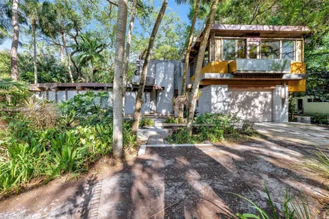 a living room with furniture a table and chairs
