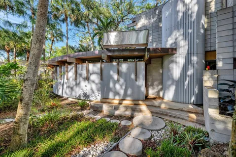 a living room with furniture fireplace and a floor to ceiling window
