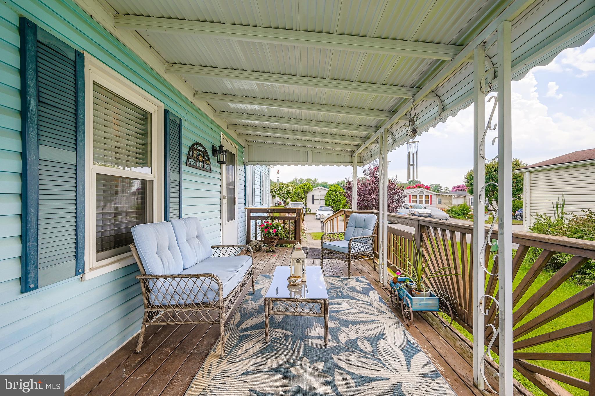 a view of a chairs and table in the balcony