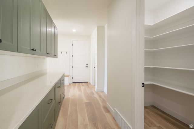 3322 250 S Street Vernal, UT 84078 - Photo 10 of 37 Entryway featuring light wood-finish flooring, a built-in bench, and coat hooks