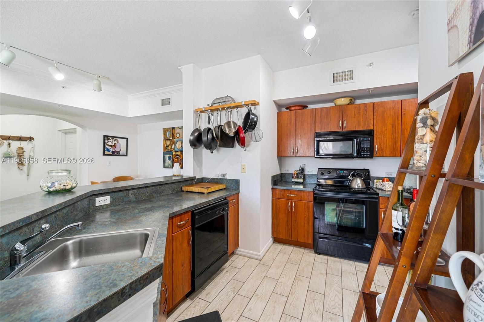 9172 Collins Avenue, Unit 210 Surfside, FL 33154 - Photo 11 of 41 a kitchen with stainless steel appliances granite countertop a sink a stove and a refrigerator