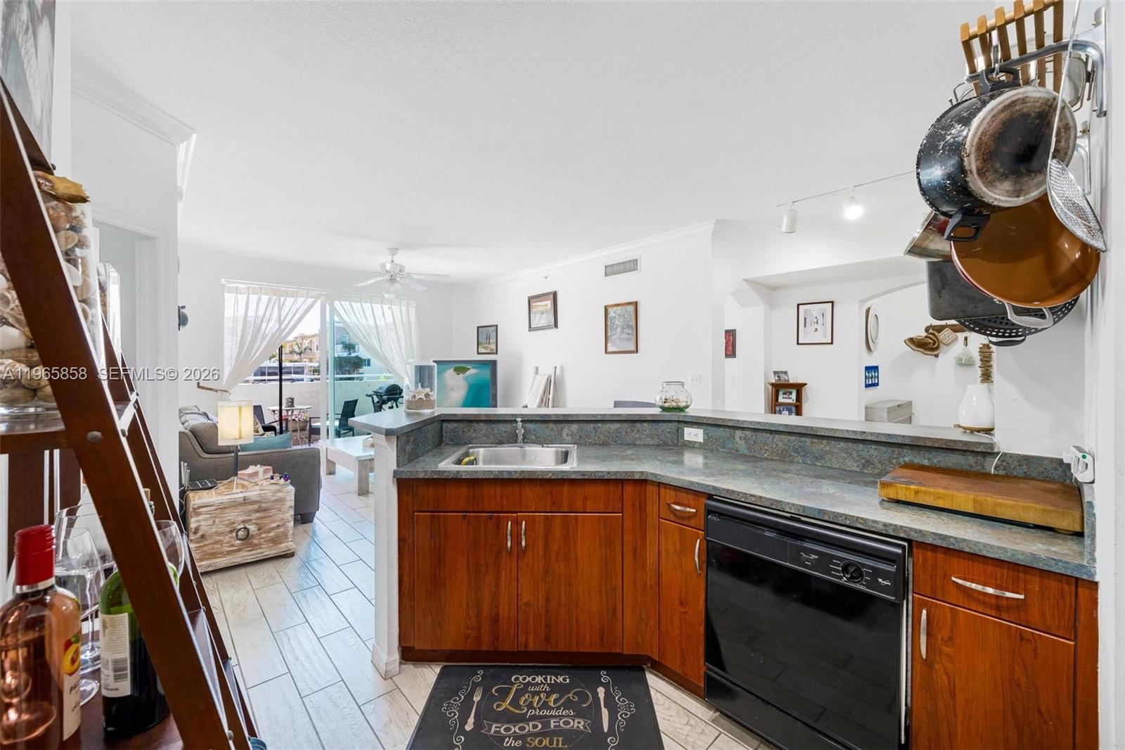 9172 Collins Avenue, Unit 210 Surfside, FL 33154 - Photo 12 of 41 a kitchen with a sink and a stove with wooden floor