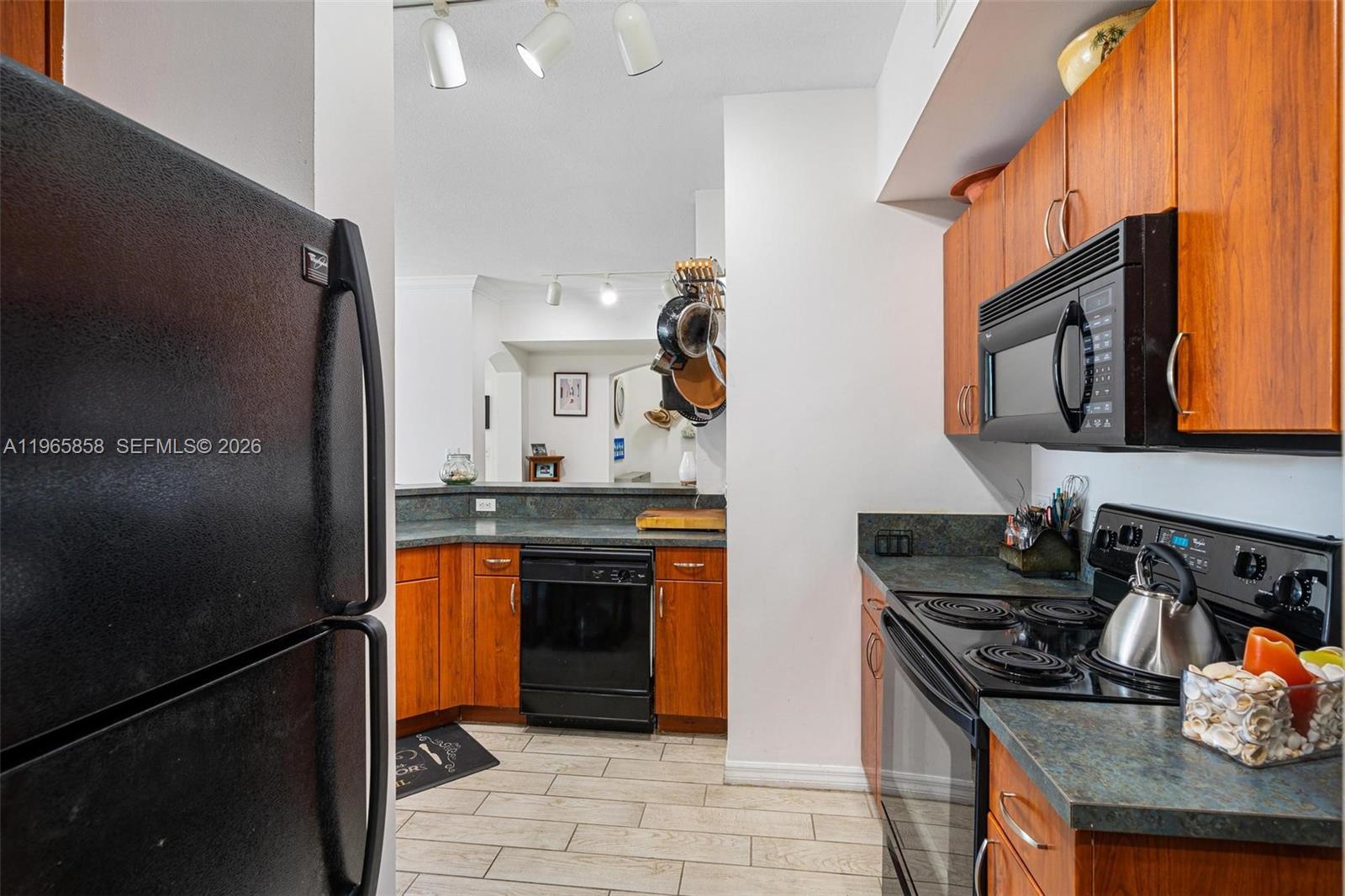 9172 Collins Avenue, Unit 210 Surfside, FL 33154 - Photo 13 of 41 a kitchen with stainless steel appliances granite countertop a stove sink and refrigerator